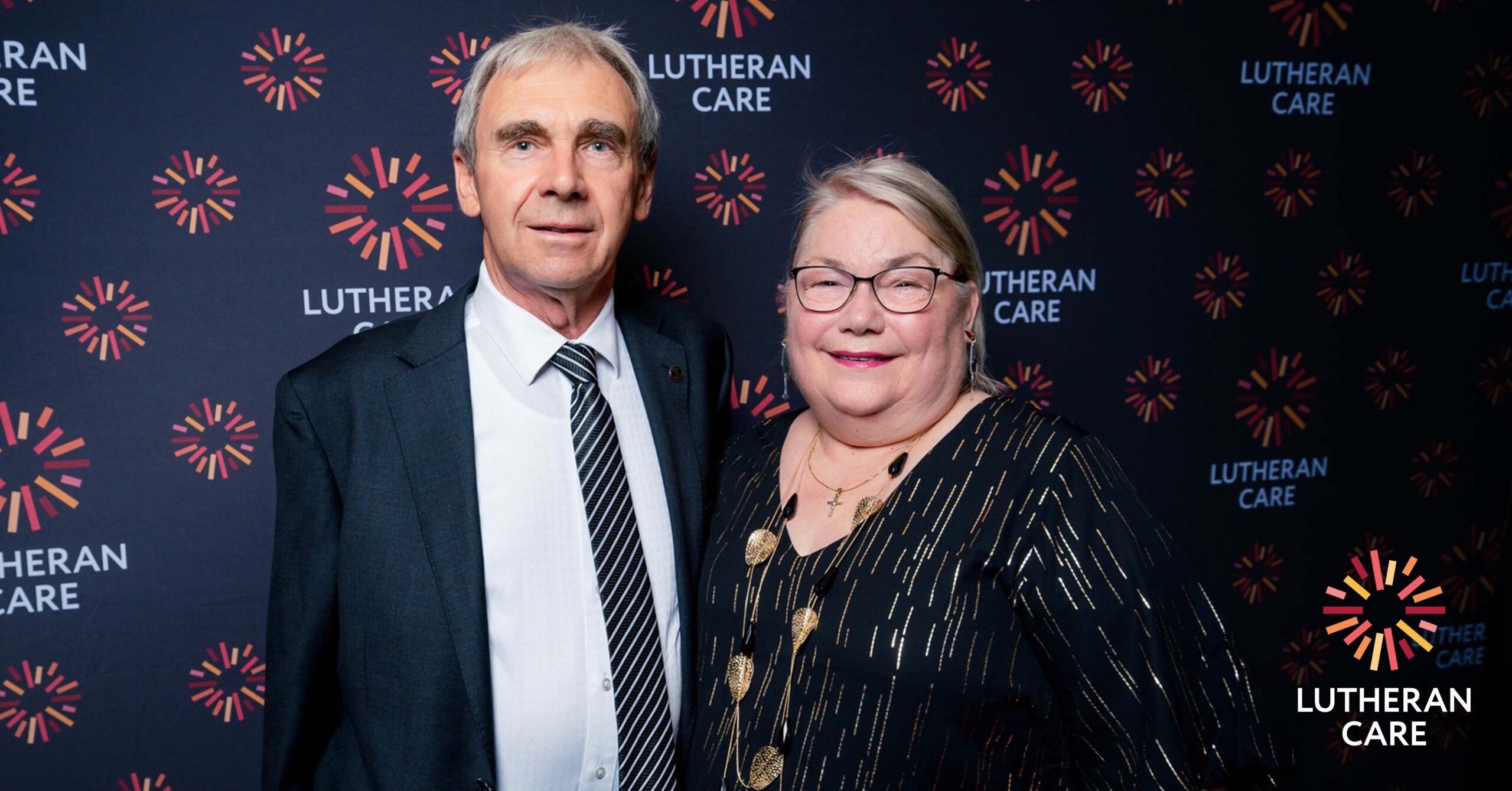 Leonie at an event with her husband Ron. The Lutheran Care logo appears in the bottom right hand corner.