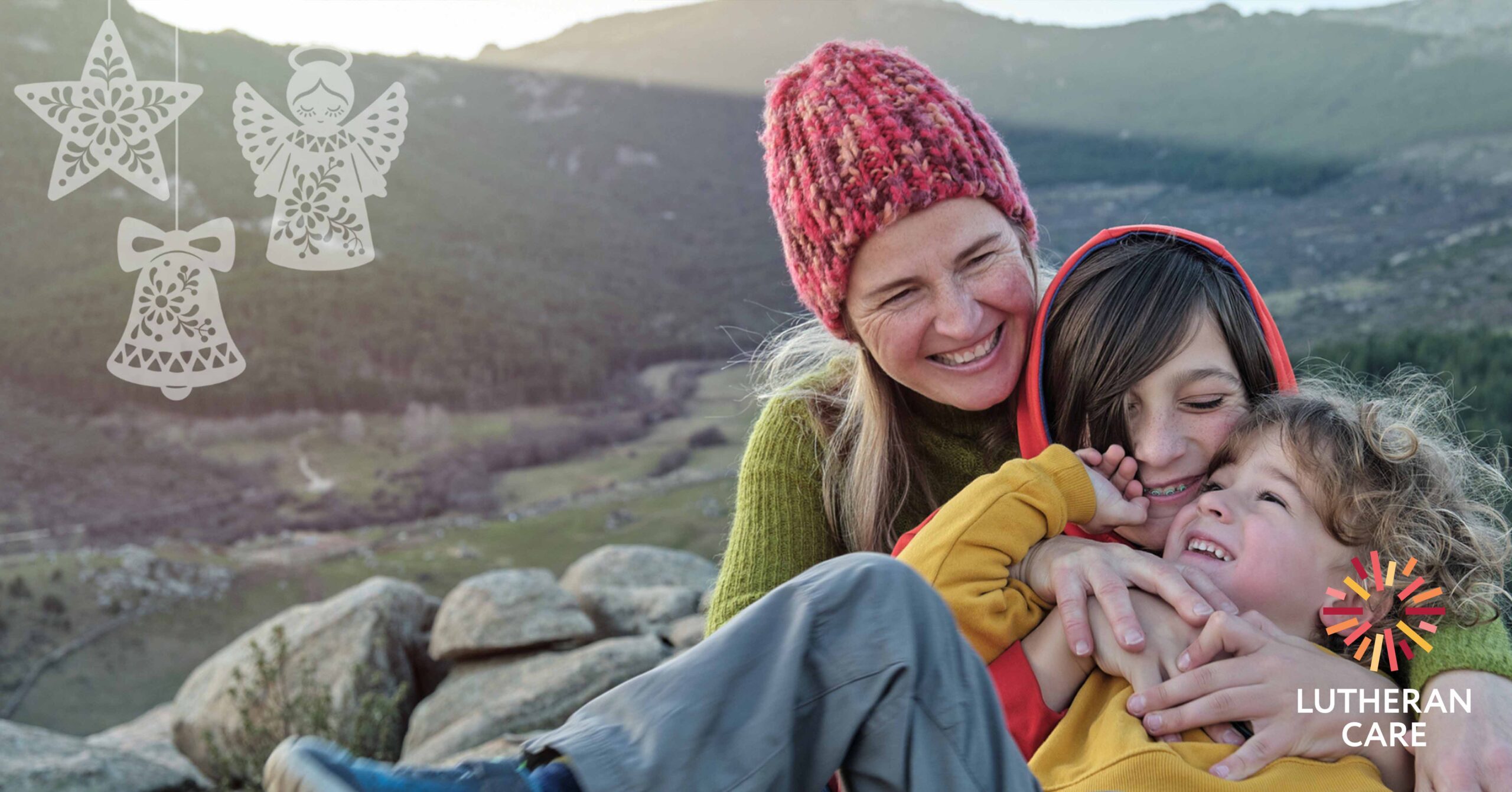 Mother and two sons hugging and laughing. The Lutheran Care logo appears in the bottom right hand corner.