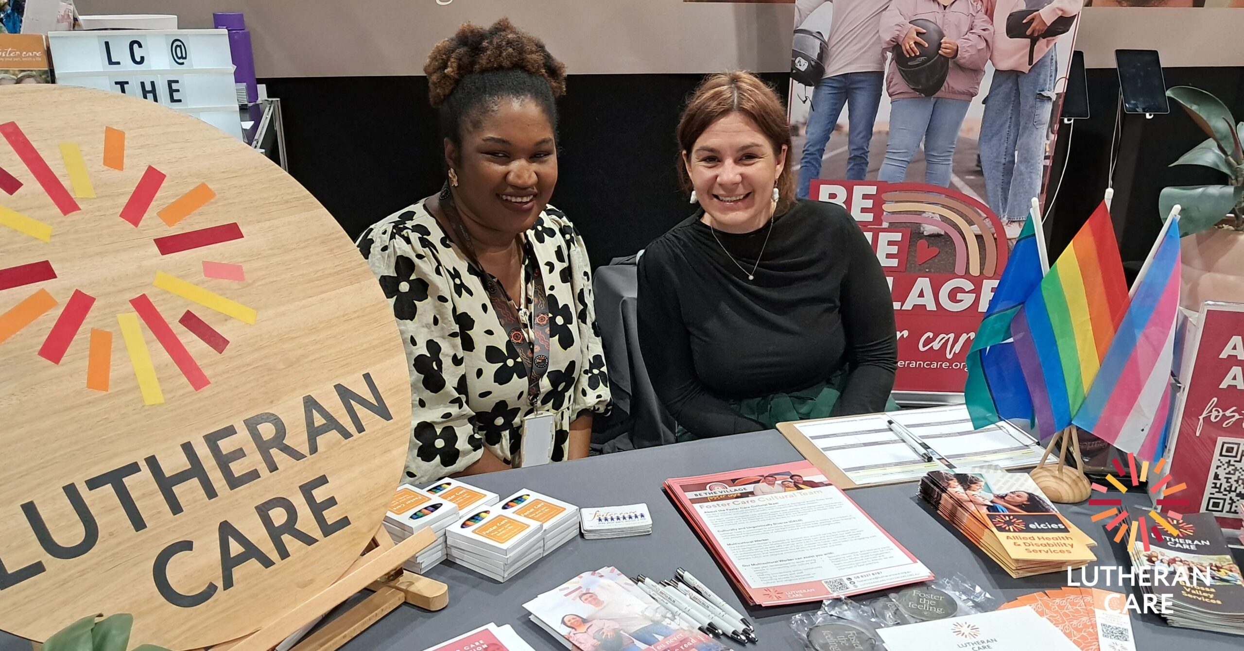 Genevieve at an event with a fellow Foster Care worker. The Lutheran Care appears in the bottom right hand corner.