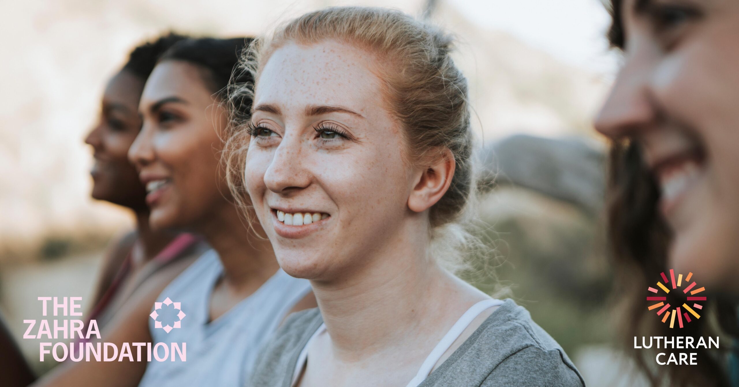 A woman with a group of other women smiles at something of camera. The Zahra Foundation and Lutheran Care logos appear at the bottom of the image.