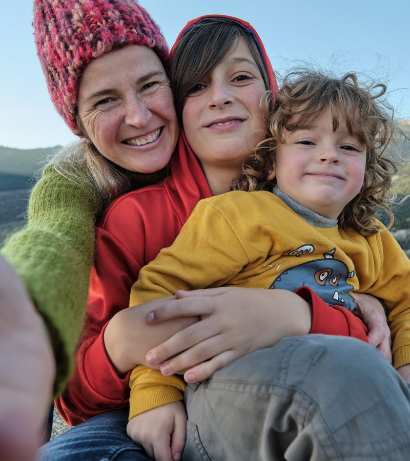 Happy mother making a selfie with her children in nature